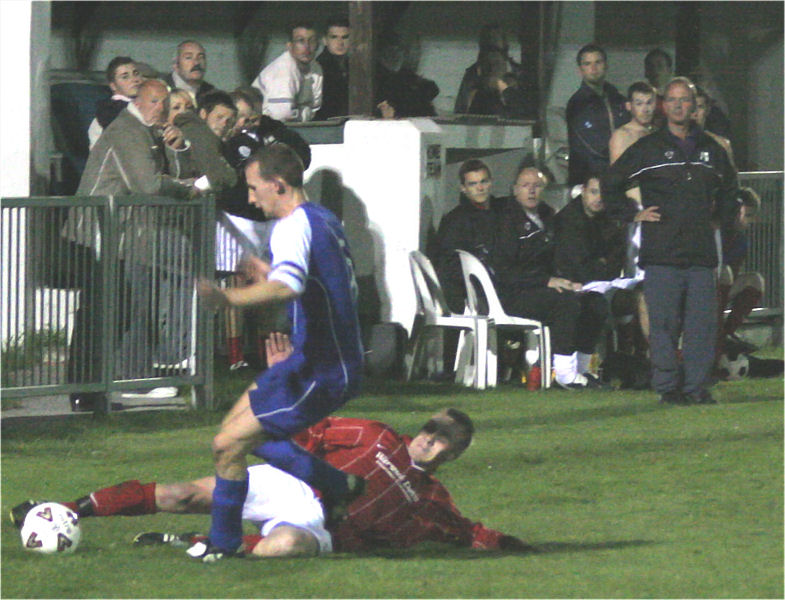 Vic Short and the Arundel bench watch as Andy Beech is tackled by Lee Barnard 
