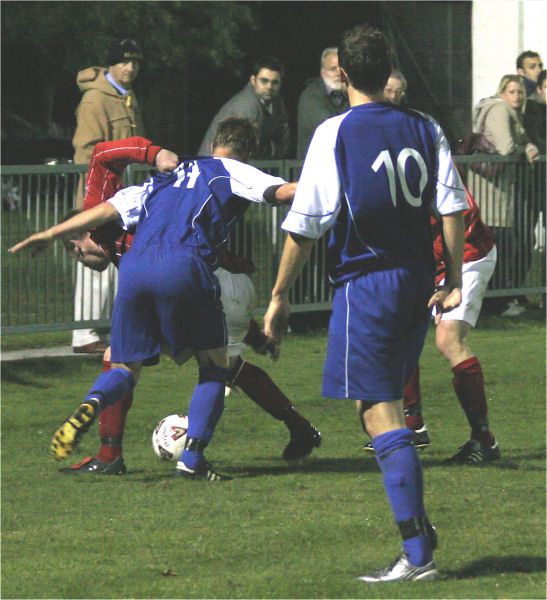 Rob Grove tangles with Wesley Mills (14) watched by Graham Martin (10)
