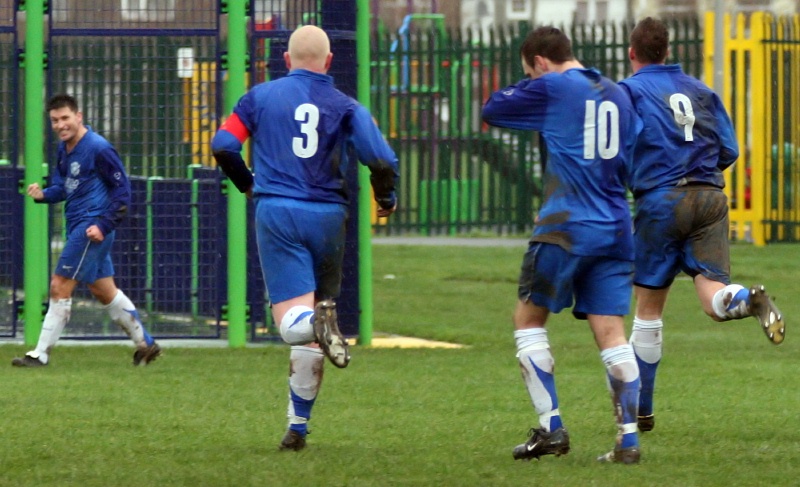 ... and the Rustington players race over to Terry Withers who provided the cross
