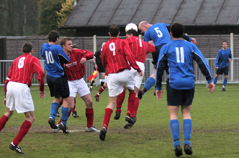 Jason Wimbleton (7) and Tony Miles (5) go for a header
