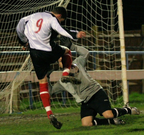 Dave Angell blocks this attempt by Michael Frangou
