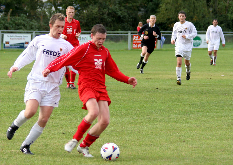 Ali Bance keeps the ball away from Danny Curd
