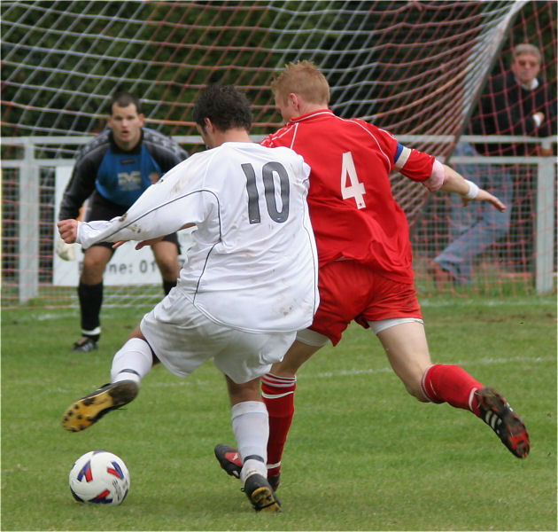 Tom Manton (10) has an attempt stopped by Stuart Channon (4)
