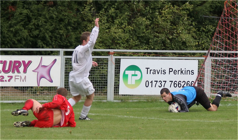 Paul Whithread  tries to tackle Danny Curd who appeals while Chris Roberts collects
