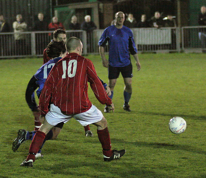 Kieron Howard and Matt Huckett chase the ball
