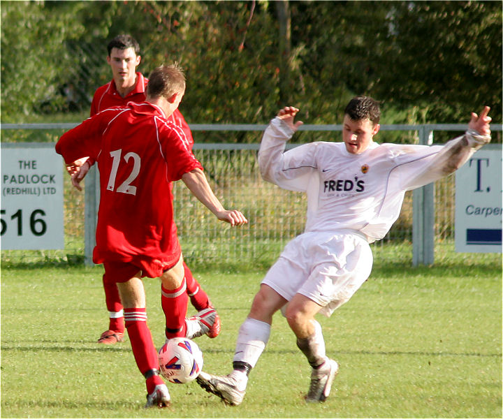 James Bracken (12) and Kieron Howard go for the ball
