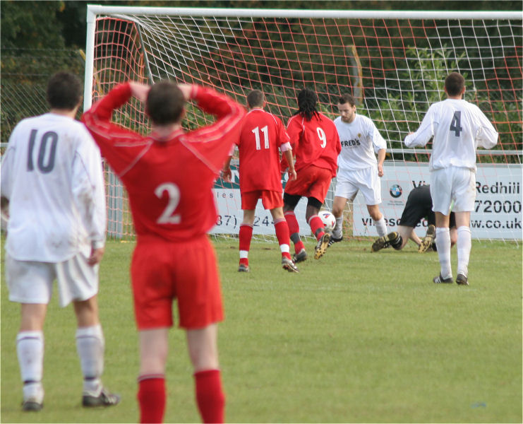 Ollie Howcroft clears this Redhill attempt in the last minute under pressure from Dave Fleming (9) and Jamie Dean (11)
