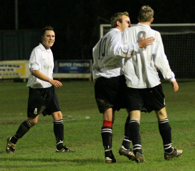 Josh Biggs congratulates Tom Lawley on scoring for East Preston
