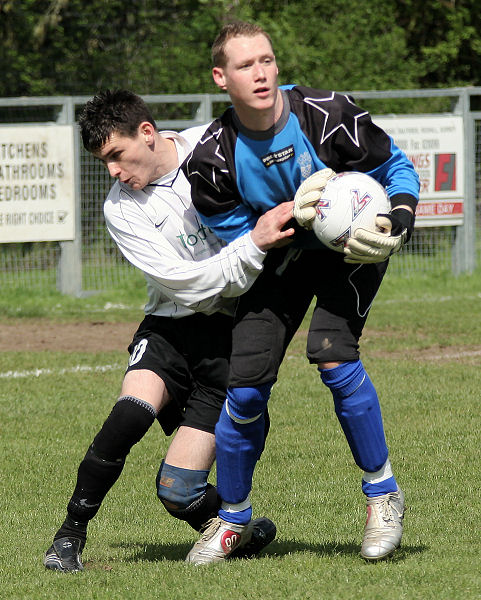 Dan Kelton grabs the ball in front of Sonny Banks. Redhill have to win and East Preston need a draw to avoid relegation
