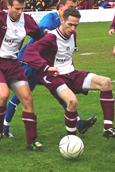 Danny Stassinos and Jon Waite shield the ball out of play
