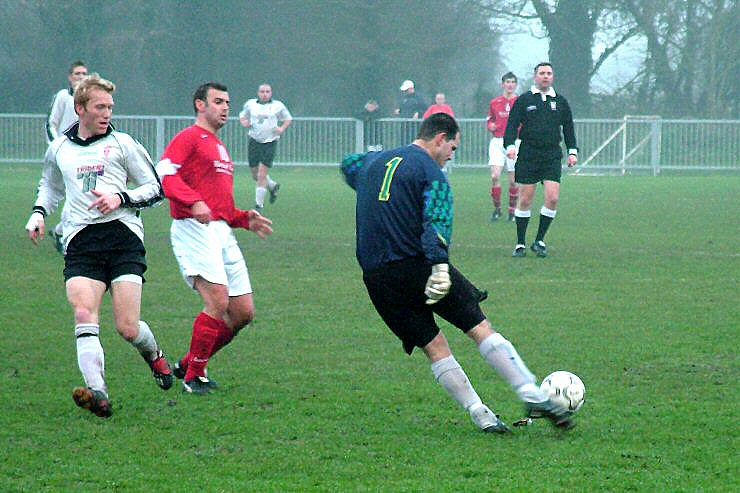 Chris Roberts (Redhill) clears as Arundel's Miles Scerri is ready to pounce on any mistake
