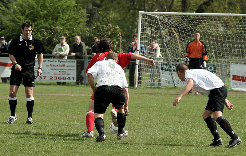 Stephen Gillett goes into the area chased by Paul Brown
