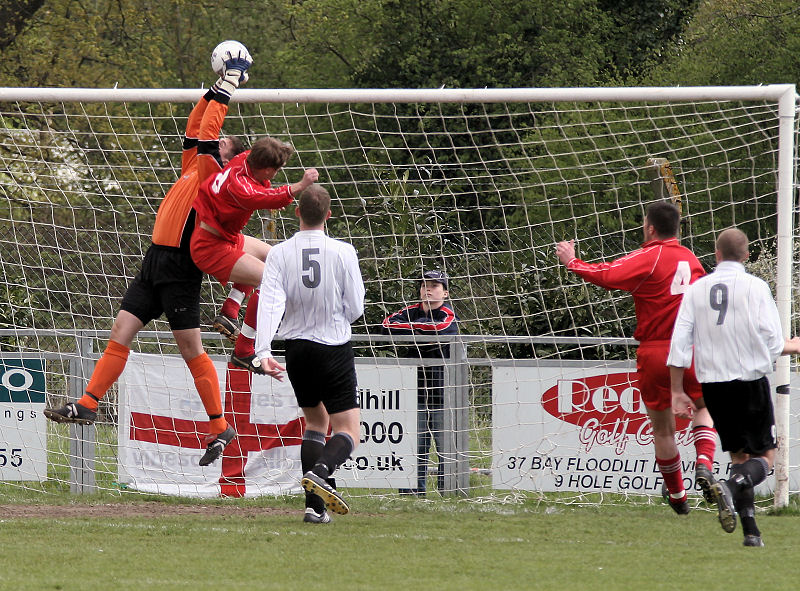 Simon Davey collects under a challenge from Justin Jones
