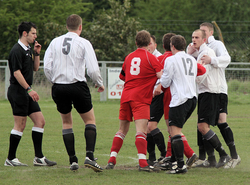 Referee Tim Robinson moves in as tension rises ...
