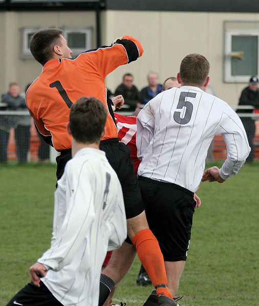 Simon Davey punches away from Luke Jones
