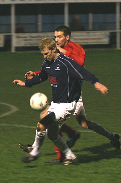 Justin Harris wins the ball from Chris Morrow
