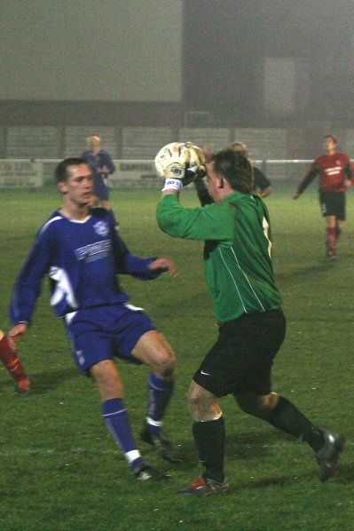 Graham Leach collects the ball in front of Kev Clayton 
