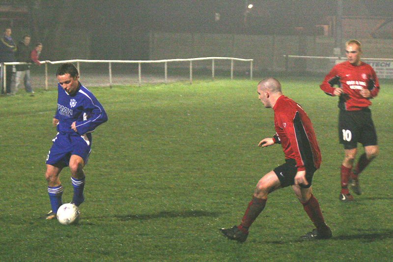Dave Oakes on the ball watched by Ross Sawyer
