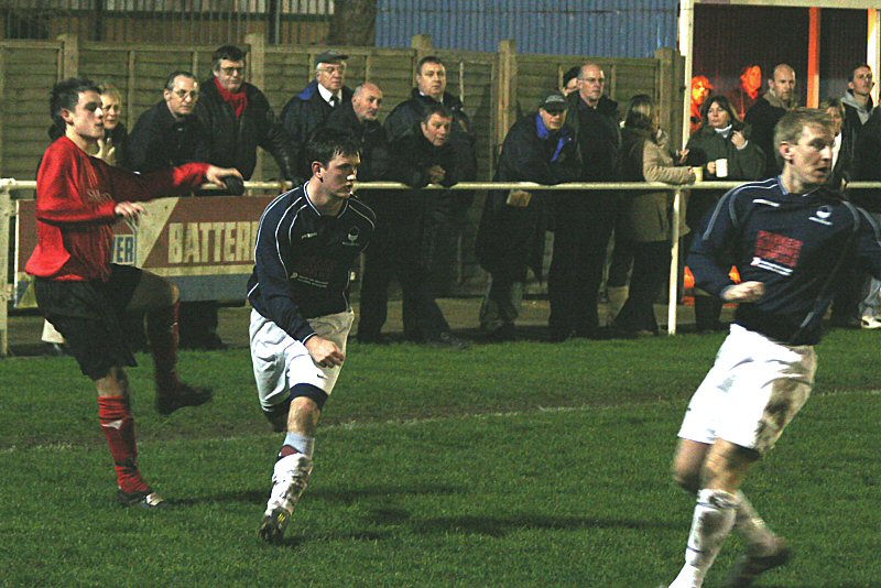 Justin Harris watches as Adam Hunt gets a cross in despite the efforts of Craig Ottley 
