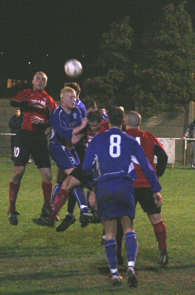 Kev Clayton (8) watches as Russ Tomlinson and Craig Brown are in the thick of the action
