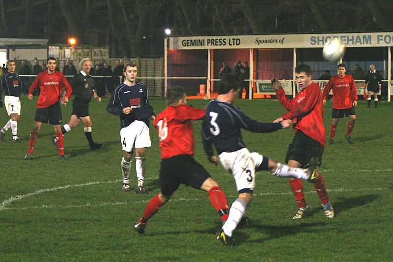 Craig Ottley gets in a clearance ahead of Jan Miller
