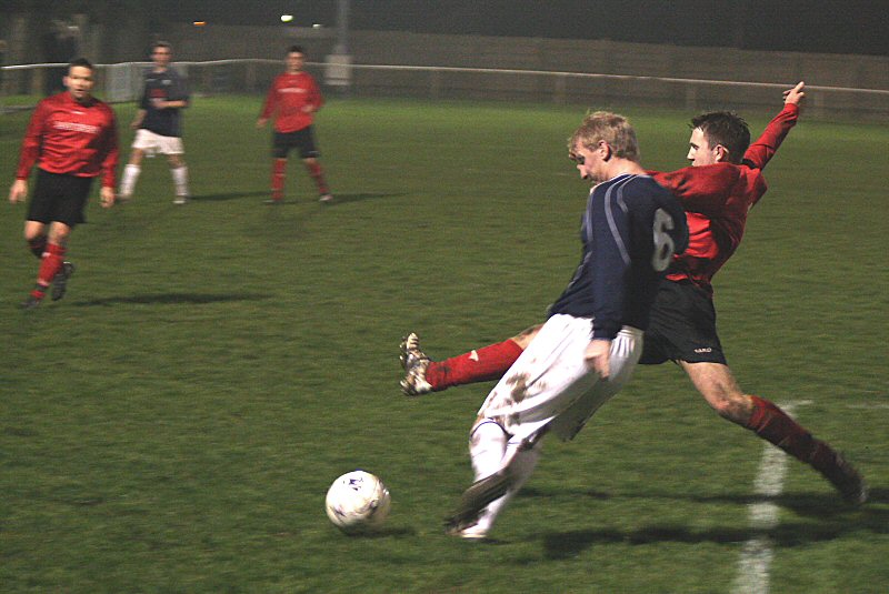 Danny Curd stretches to try and get the ball away from Justin Harris
