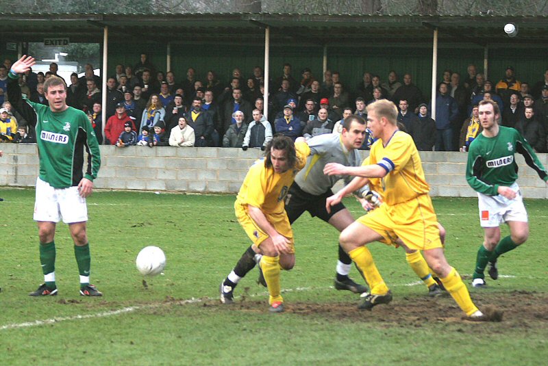 Andy Martin and Steve Butler try and get the ball before keeper Tommy Dunn
