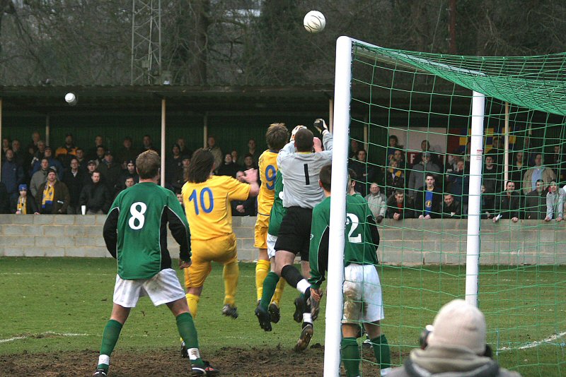 Andy Martin, Richard Butler and keeper Tommy Dunn all go up for this corner

