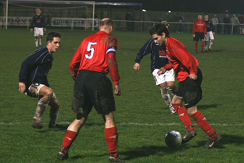 Tom Manton on the ball with Tony Miles (5) covering and Bobby Godfrey (10) looking to get in
