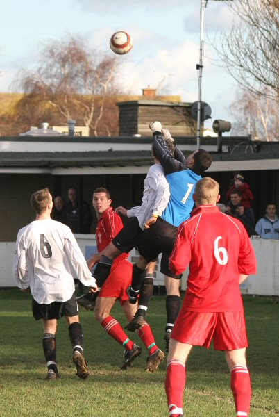 Chris Roberts punches the ball off the head of Josh Biggs
