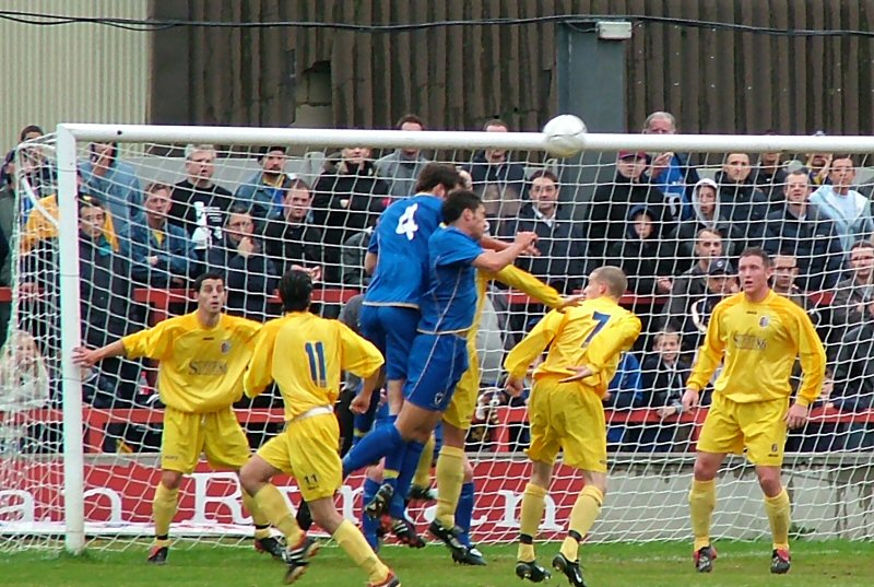 Antony Howard and Jay Conroy go for the same ball as Hasting's Steve Ringwood and Ryan Peters close in
