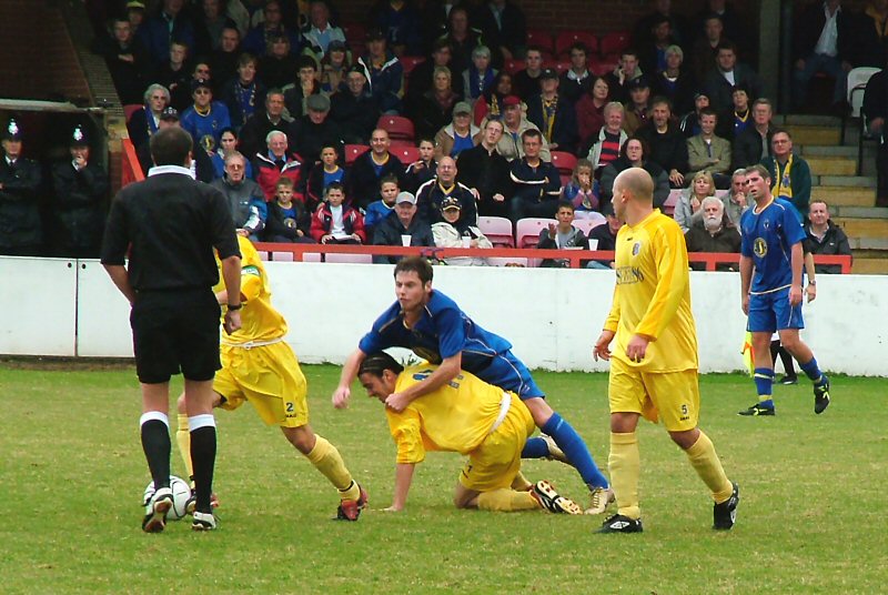 Players from both teams try to get the ball from the ref!
