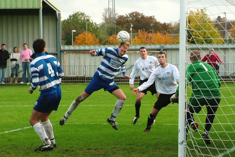 James Deacons (E&E) gets a clearing header in ahead of Dave Walker and Jim Smith (EP)
