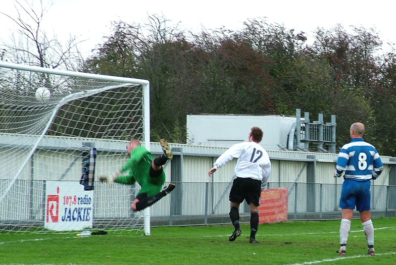 Warren Aburn E&E pulls off a great save from Lee Farrell's back header
