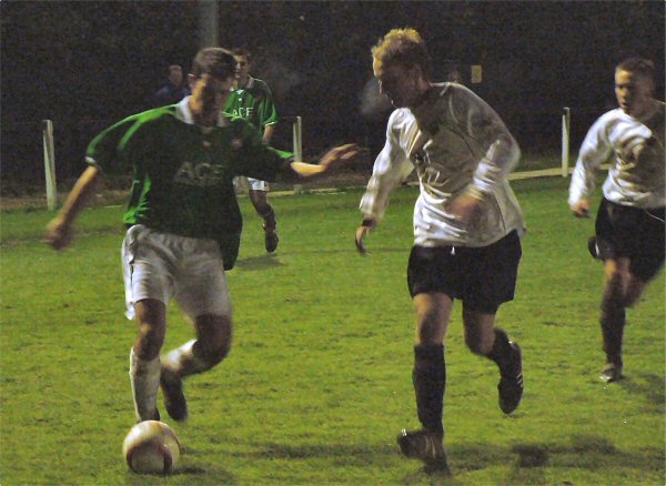 Darren Akmenkalns being tracked by Dave Hall with Matt Huckett close up
