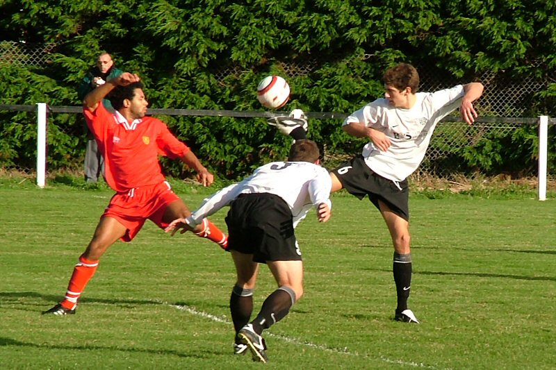 Uxbridge's Lee Tunnell goes for the ball with Andy Appleton and Chris Hall
