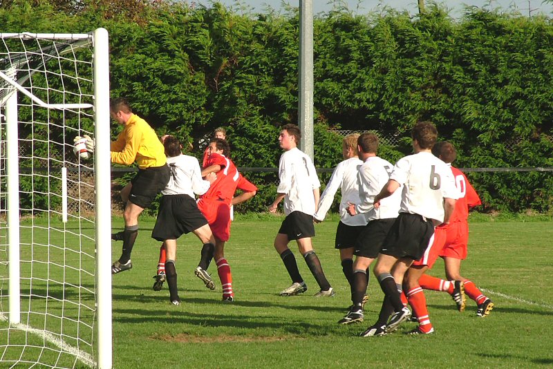 McCarthy shields the ball from Uxbridge's Stuart Lake(11) and Jim Smith is on hand to make sure.
