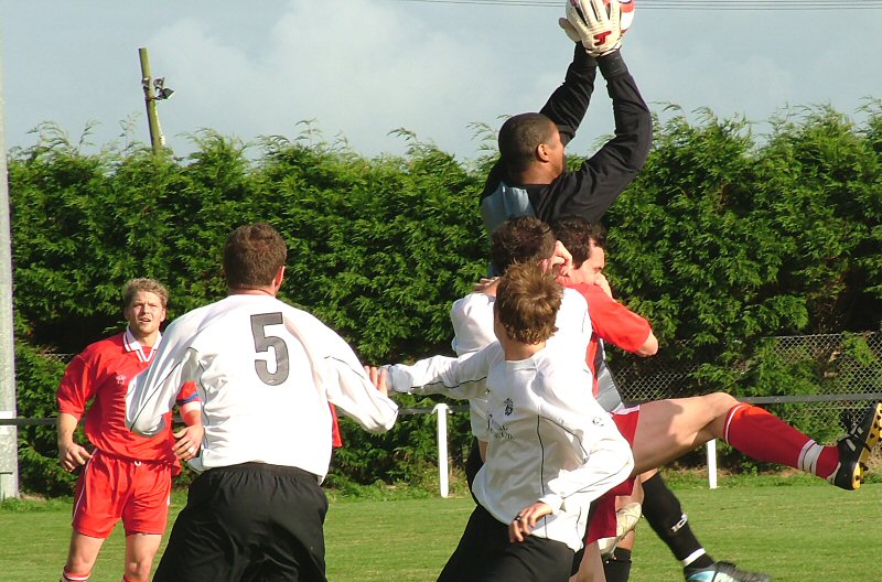 Uxbridge keeper Ray Francis collects under pressure from Andy Appleton, Josh Sutcliffe and Josh Biggs
