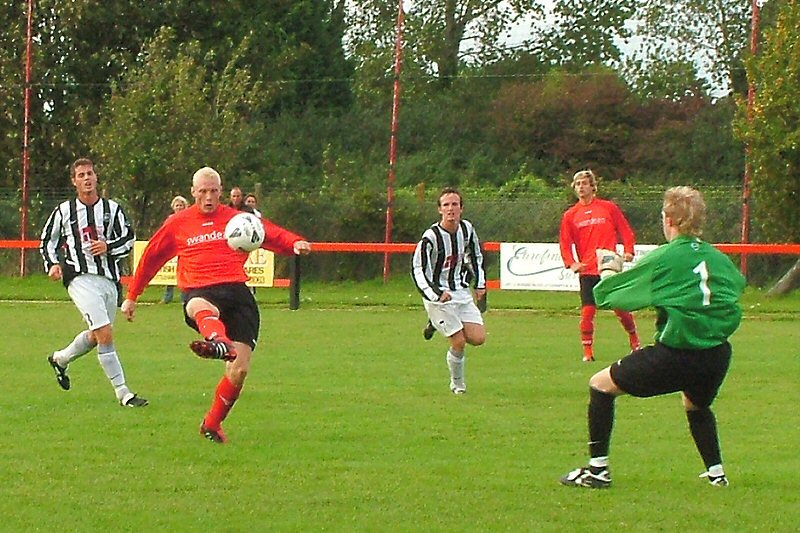 Kane Evans lifts it over Tom Harvey for his second goal
